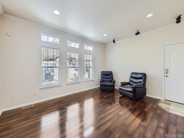 sitting room with crown molding and dark hardwood / wood-style flooring