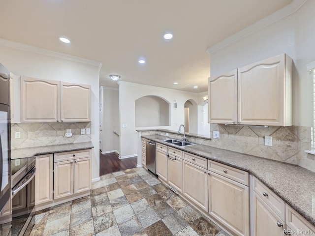 kitchen with crown molding, tasteful backsplash, stainless steel appliances, and sink