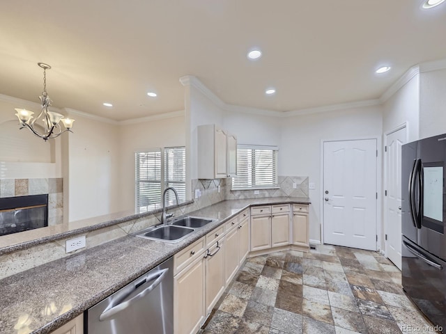 kitchen featuring sink, backsplash, black fridge, stainless steel dishwasher, and ornamental molding