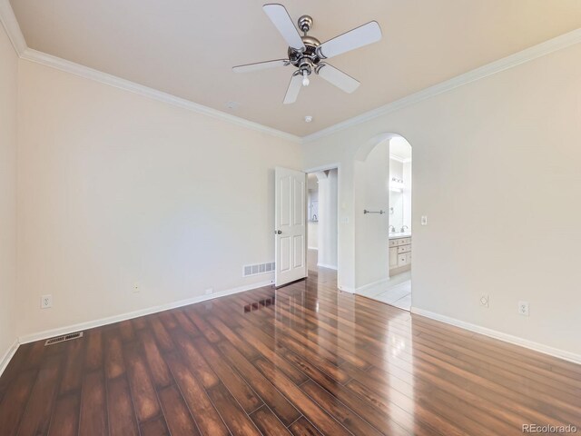 spare room with ornamental molding, dark hardwood / wood-style floors, and ceiling fan