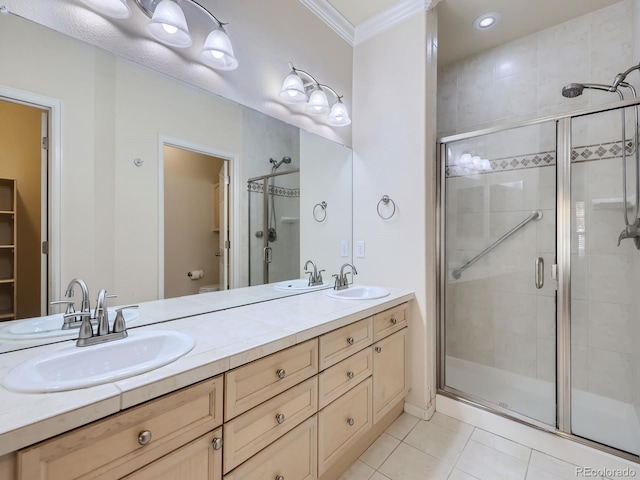 bathroom featuring a shower with door, toilet, tile patterned floors, vanity, and ornamental molding