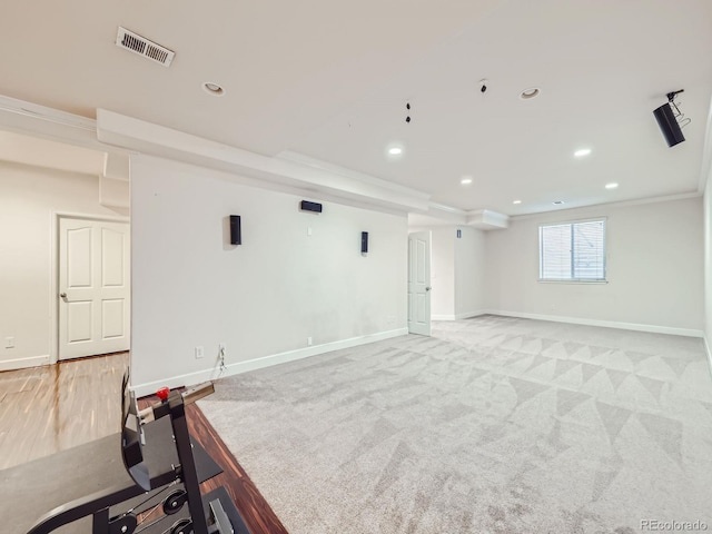 interior space featuring crown molding and light colored carpet