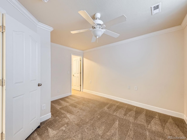 carpeted empty room with crown molding and ceiling fan