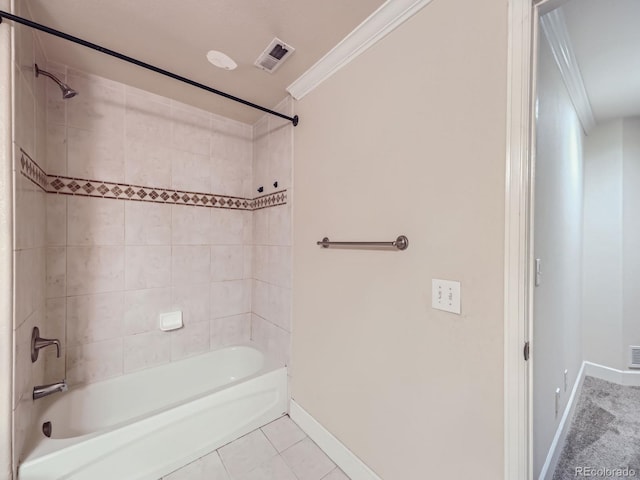 bathroom featuring crown molding, tile patterned flooring, and tiled shower / bath