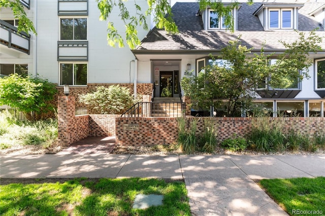 555 E 10th Ave Unit 206, Denver, CO 80203 - view of front of house with brick siding and roof with shingles