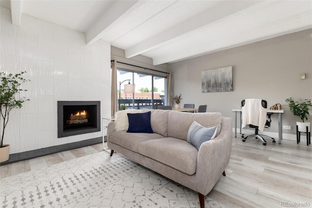 555 E 10th Ave Unit 206, Denver, CO 80203 - living room featuring beam ceiling, wood finished floors, and a fireplace