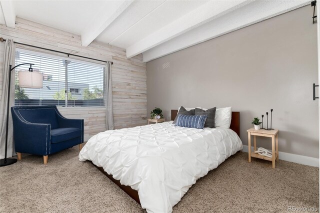 555 E 10th Ave Unit 206, Denver, CO 80203 - bedroom with wood walls, beam ceiling, and carpet