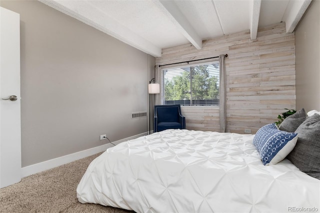 555 E 10th Ave Unit 206, Denver, CO 80203 - bedroom with wooden walls, beam ceiling, and carpet flooring