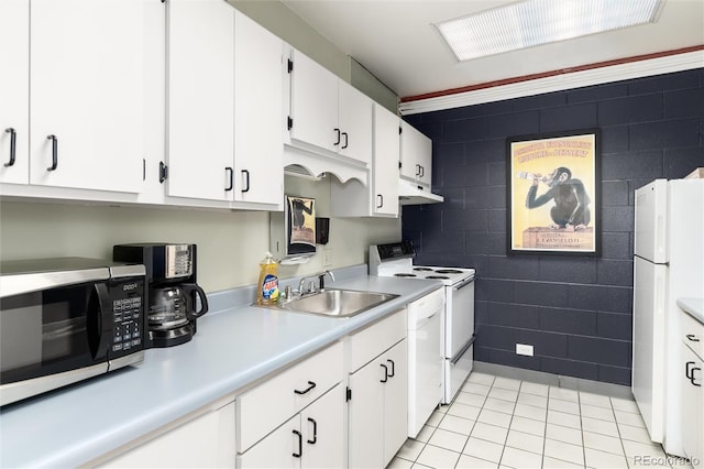 555 E 10th Ave Unit 206, Denver, CO 80203 - kitchen featuring under cabinet range hood, white appliances, tile walls, light countertops, and light tile patterned flooring