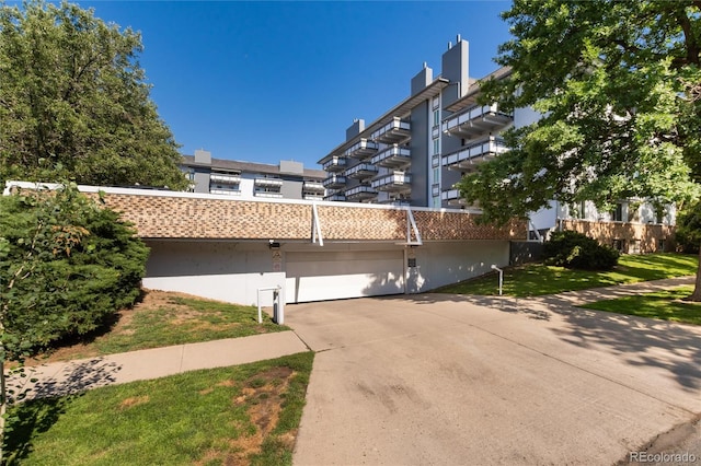 555 E 10th Ave Unit 206, Denver, CO 80203 - view of front of property featuring stucco siding and driveway