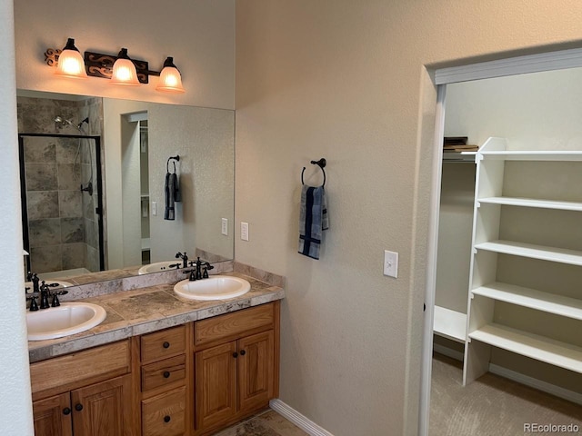 bathroom featuring vanity and a shower with shower door