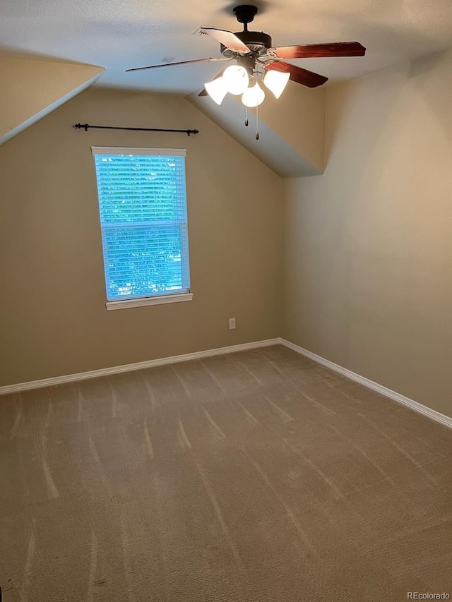 empty room with carpet floors, ceiling fan, and lofted ceiling