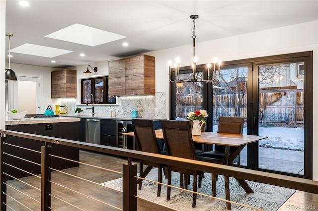 dining space with recessed lighting, a skylight, and wine cooler