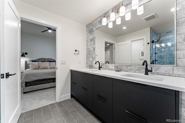 full bathroom with connected bathroom, visible vents, tiled shower, and a sink