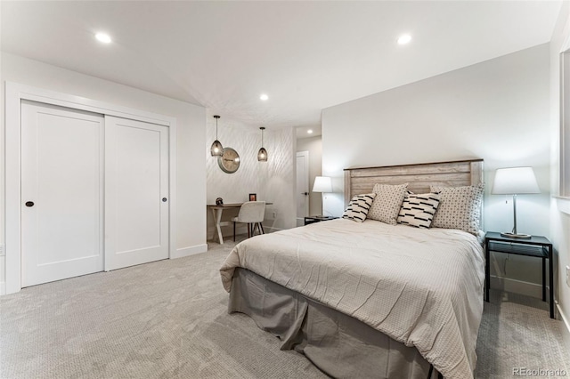 carpeted bedroom with baseboards, a closet, and recessed lighting