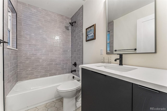 full bathroom featuring tile patterned flooring, tub / shower combination, toilet, and vanity