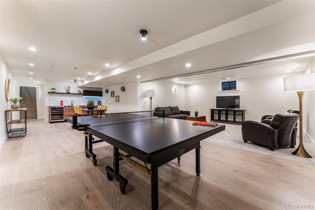 playroom featuring indoor bar, wine cooler, light wood-type flooring, recessed lighting, and baseboards