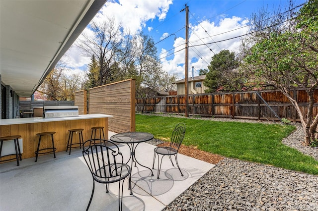view of patio featuring a fenced backyard and outdoor dry bar