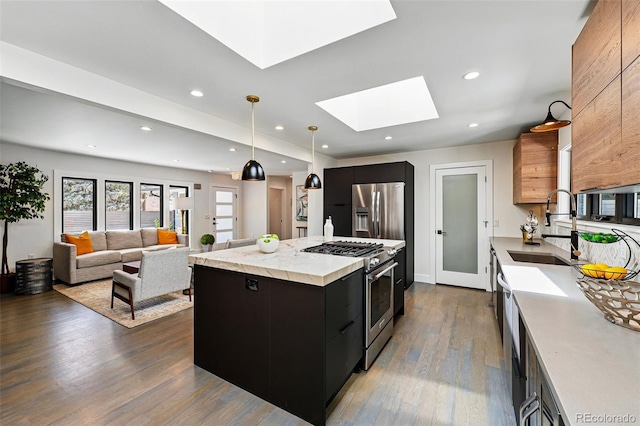 3275 19th St, Boulder, CO 80304 - kitchen featuring appliances with stainless steel finishes, modern cabinets, a sink, dark cabinetry, and recessed lighting