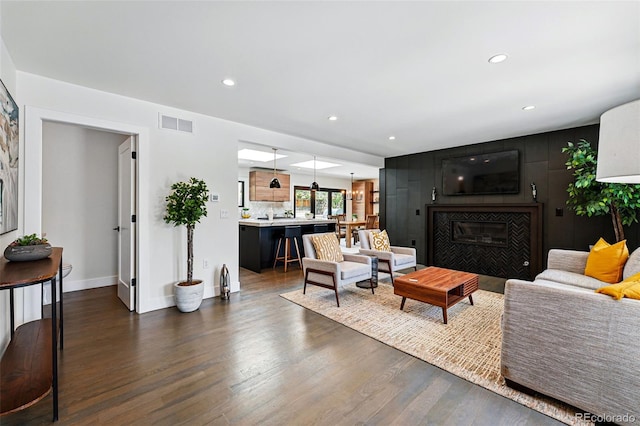 3275 19th St, Boulder, CO 80304 - living area with a tiled fireplace, dark wood-style floors, recessed lighting, and baseboards