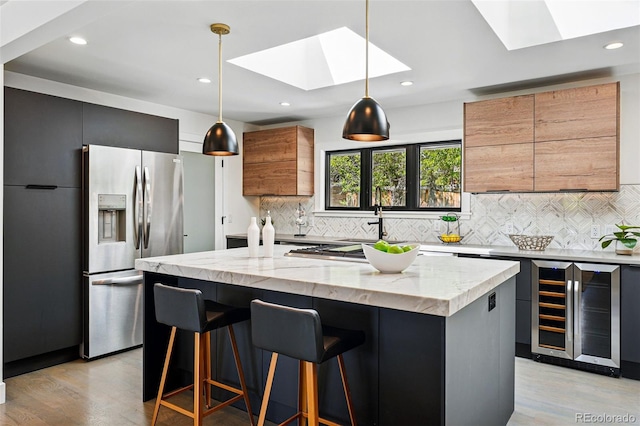 3275 19th St, Boulder, CO 80304 - kitchen with stainless steel refrigerator with ice dispenser, a skylight, wine cooler, light wood-style flooring, and recessed lighting