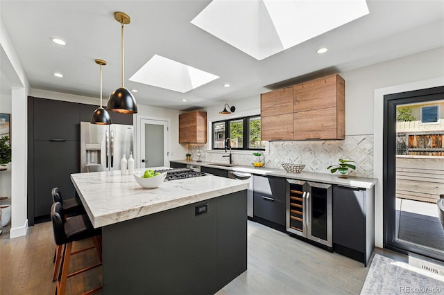 3275 19th St, Boulder, CO 80304 - kitchen with beverage cooler, stainless steel fridge, a skylight, modern cabinets, and recessed lighting