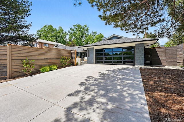 3275 19th St, Boulder, CO 80304 - view of front of house with brick siding, concrete driveway, a shingled roof, and a garage