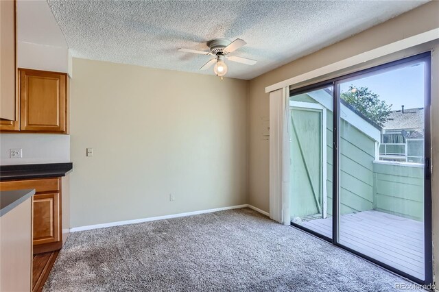 interior space with ceiling fan and a textured ceiling