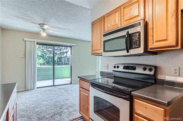 kitchen featuring ceiling fan, light carpet, a textured ceiling, and appliances with stainless steel finishes