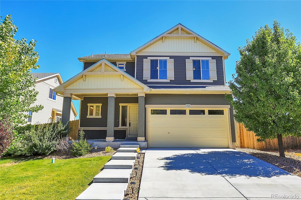 craftsman house featuring a garage, a front lawn, and covered porch