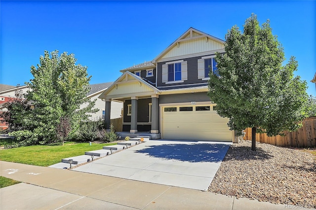 craftsman house with a garage and a front lawn