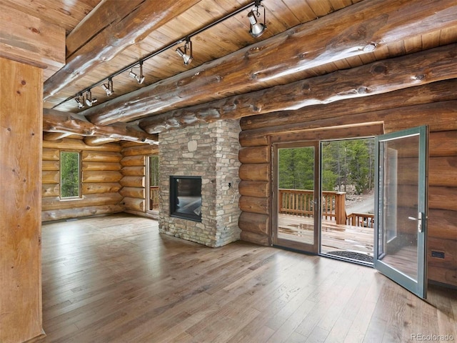 unfurnished living room with hardwood / wood-style flooring, a fireplace, wood ceiling, and rail lighting