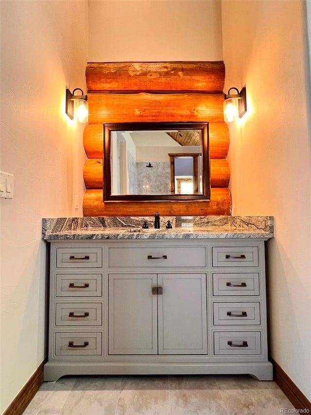 bathroom featuring vanity and rustic walls