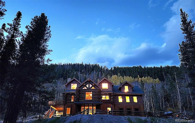 733 Rainbow Rd, Idaho Springs, CO 80452 - view of front of home featuring a forest view, a chimney, and log exterior
