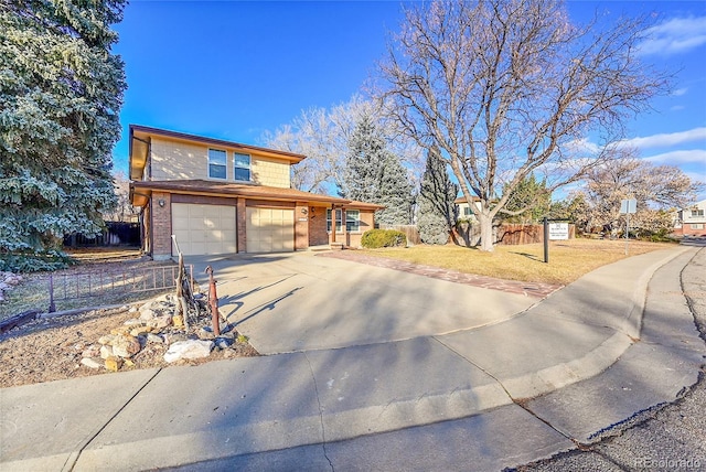 view of front of property featuring a garage and a front lawn