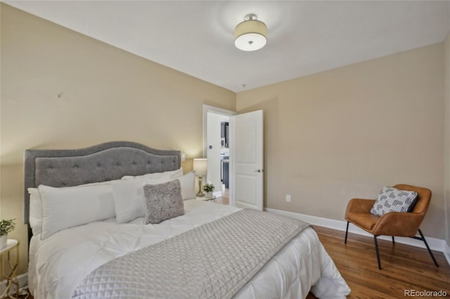 bedroom with wood finished floors and baseboards