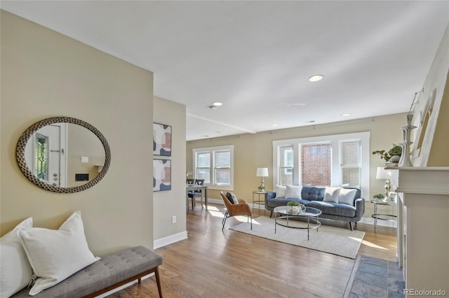 living room with recessed lighting, baseboards, and wood finished floors