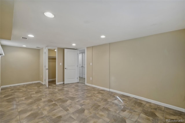 finished basement featuring visible vents, baseboards, and recessed lighting