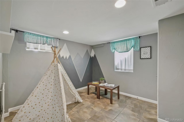 rec room with visible vents, plenty of natural light, and baseboards