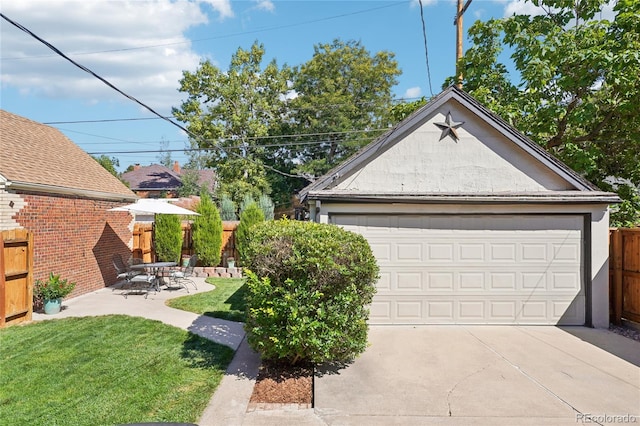 detached garage featuring fence