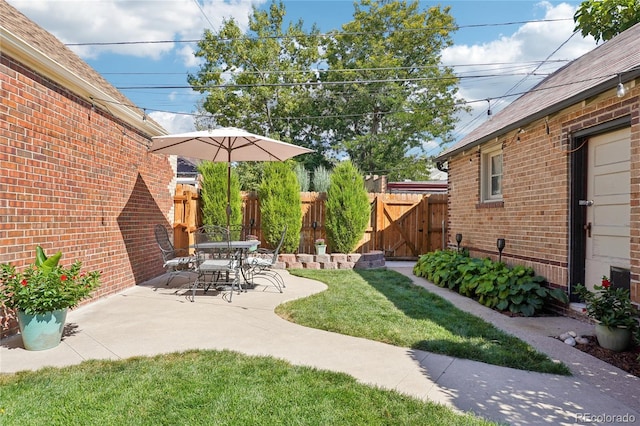 view of yard featuring a gate, a patio area, and fence