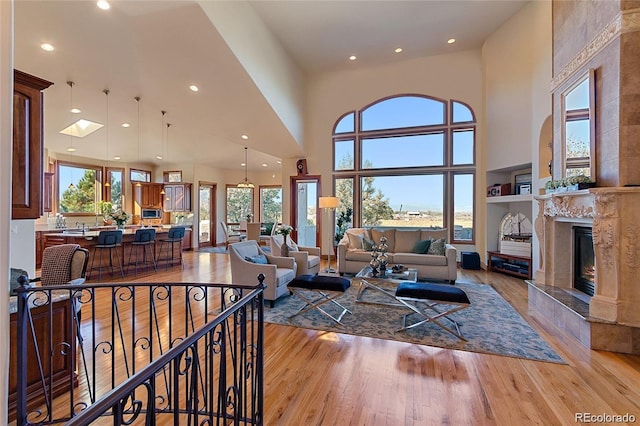 11541 Warrington Ct, Parker, CO 80138 - living area with recessed lighting, light wood-style floors, a premium fireplace, and a towering ceiling