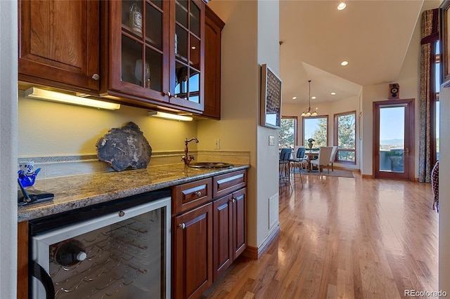 11541 Warrington Ct, Parker, CO 80138 - bar featuring beverage cooler, a sink, light wood finished floors, recessed lighting, and baseboards