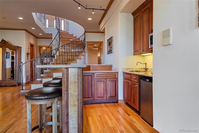 11541 Warrington Ct, Parker, CO 80138 - bar area featuring ornamental molding, a sink, light wood finished floors, stairs, and appliances with stainless steel finishes