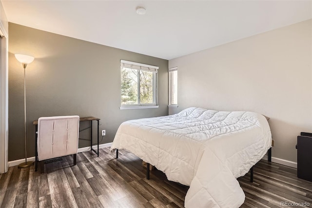 bedroom featuring baseboards and dark wood-style floors