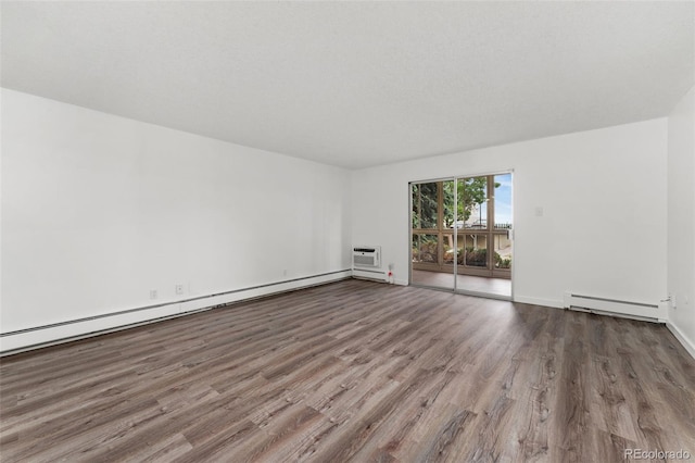 3022 S Wheeling Way Unit 109, Aurora, CO 80014 - unfurnished room featuring a baseboard heating unit, wood finished floors, and baseboards