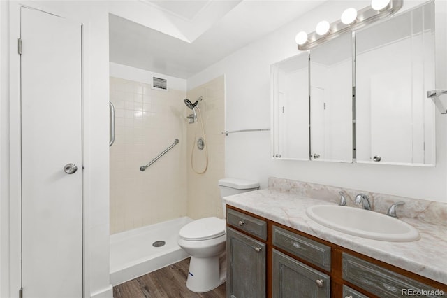 3022 S Wheeling Way Unit 109, Aurora, CO 80014 - bathroom with vanity, toilet, a stall shower, and wood finished floors