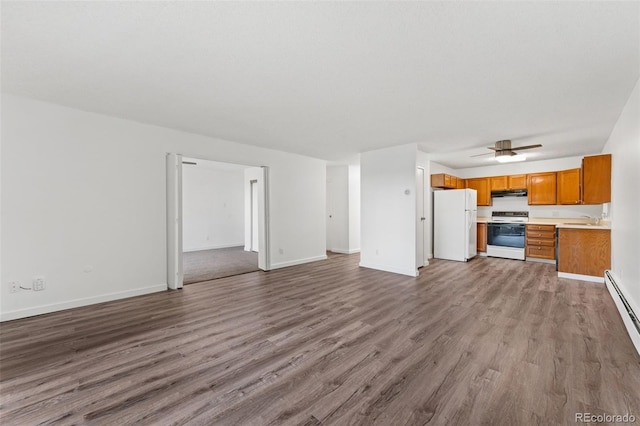 3022 S Wheeling Way Unit 109, Aurora, CO 80014 - unfurnished living room featuring a sink, wood finished floors, baseboards, and ceiling fan