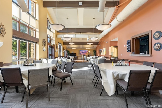 3022 S Wheeling Way Unit 109, Aurora, CO 80014 - dining room featuring a high ceiling, carpet, and plenty of natural light