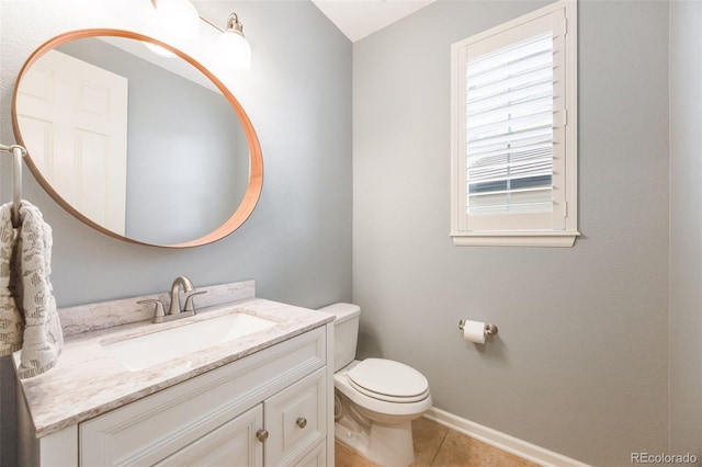 bathroom featuring toilet, tile patterned flooring, and vanity